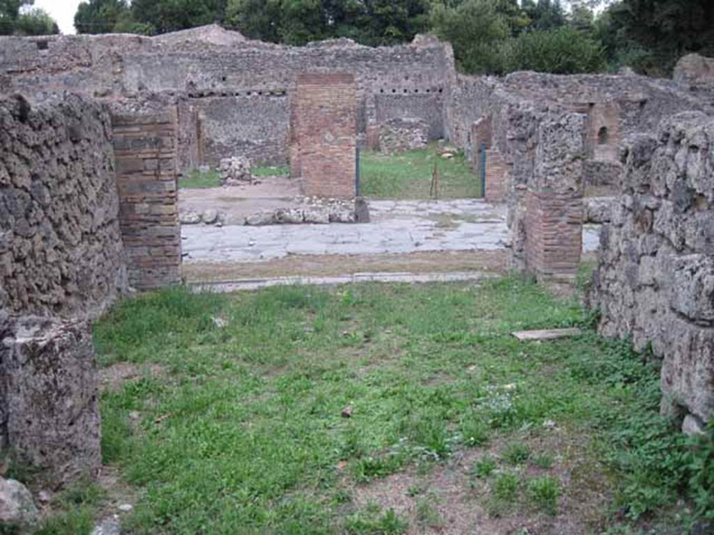 VIII.7.4 Pompeii. September 2010. Looking east from rear room across shop to entrance on Via Stabiana. Photo courtesy of Drew Baker.
According to Mau in BdI –
Note that neither of the shops (VIII.7.3 or 4) have the usual podium, and that the rear rooms are rather spacious. In the middle of the second shop (VIII.7.4) stands a graceful marble table, the support of which is adorned with a bust of a Satyr wearing a fawn’s skin (nebris). Evidently these are not really shops, but taverns, and locations of a caupona.
(Si noti, che in nessuna delle botteghe si trova il solito podio, e che le retrobotteghe sono stanze piuttosto spaziose. In mezza alla seconda bottega sta un grazioso tavolino di marmo, il cui sostegno era adorno d’un busto di Satiro colla nebris. Evidentemente queste non sono propriamente botteghe, ma taverne, locali d’una caupona.)
See Bullettino dell’Instituto di Corrispondenza Archeologica (DAIR), 1875, p.126.