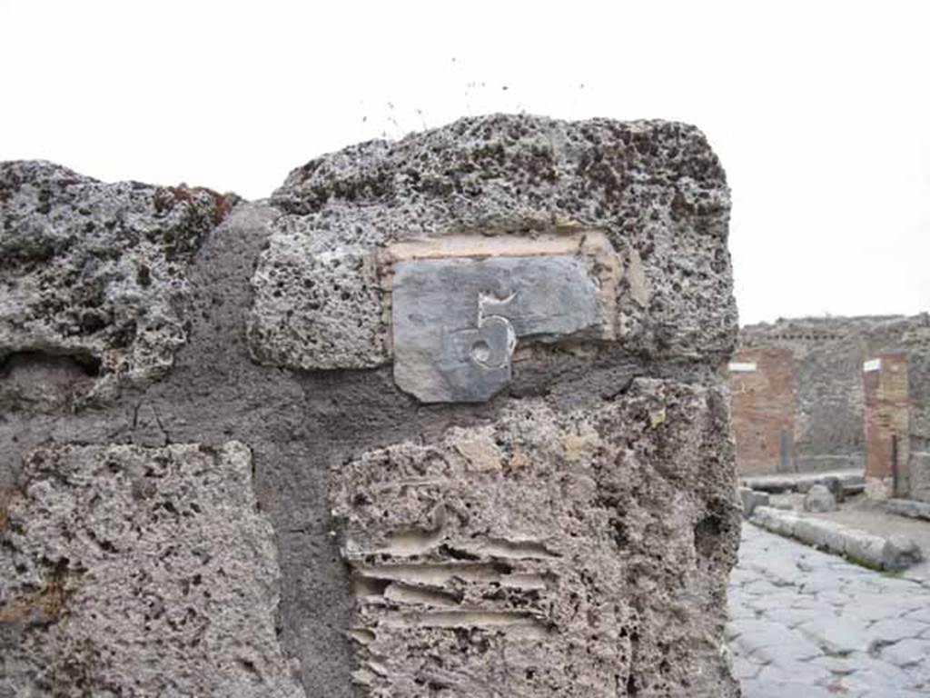 VIII.7.5 Pompeii. September 2010. ID plate on north wall of entrance. Photo courtesy of Drew Baker.