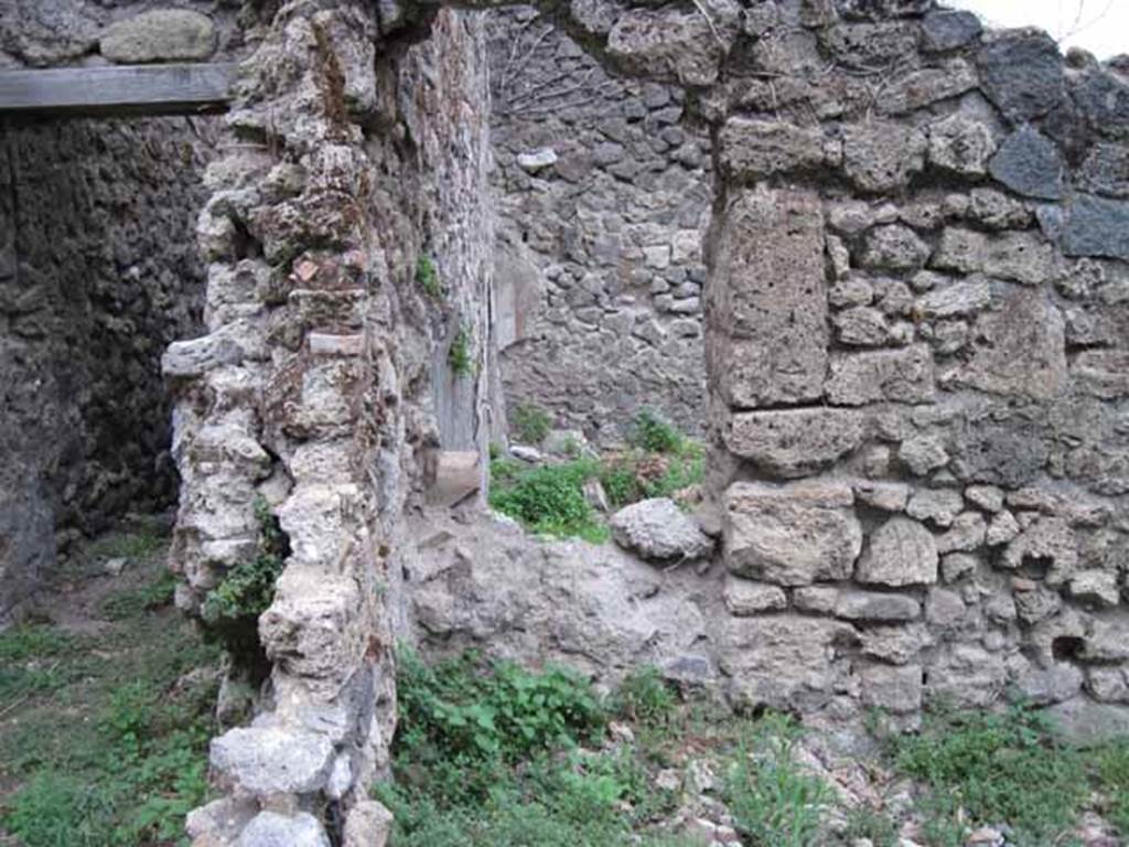 VIII.7.6 Pompeii. September 2010. On the left, corridor leading north from kitchen area. In the centre, north-west corner of “rustic” room, with aperture through to tablinum. Photo courtesy of Drew Baker.


