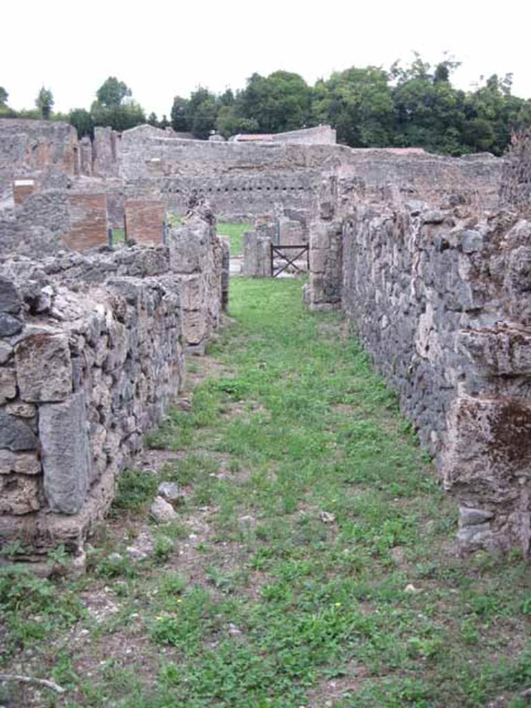 VIII.7.8 Pompeii. September 2010. Looking east along corridor towards shop entrance on Via Stabiana, from rear workshop room. Photo courtesy of Drew Baker.