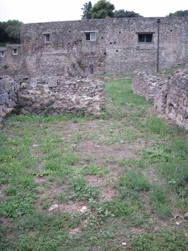 VIII.7.12 Pompeii. September 2010. Looking west across front room of shop towards rear, cubiculum on left, and corridor on right. The 2008 PARP:PS excavation found remains form several phases of development. These included a tank, a waste chute, a drain and door stops that were located in the centre of the room away from the current threshold. Photo courtesy of Drew Baker.