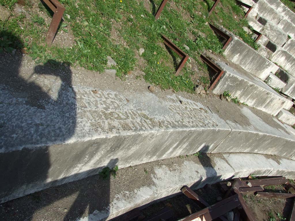 VIII.7.20 Pompeii. December 2007. Large Theatre. Bronze letters set into the marble stone seating of the cavea. 
The inscription records the career of Marcus Holconius Rufus: 

M HOLCO - - NIO V F //UFO
II V I D - - QUINQUIENS
ITER QUINQ TRIB MIL A P
FLAMINI AUG PATR COLO D D

M(arco) Holconio M(arci) f(ilio) Rufo / IIv(iro) i(ure) d(icundo) quinquiens / iter(um) quinq(uennali) trib(uno) mil(itum) a p(opulo) / flamini Aug(usti) patr(ono) colo(niae) d(ecreto) d(ecurionum)     [CIL X 838].

Mau translates this as: 
Dedicated in accordance with a decree of the city council to Marcus Holconius Rufus the son of Marcus, five times duumvir with judiciary authority, twice quinquennial duumvir, military tribune by the choice of the people, priest of Augustus and patron of the colony. 
See Mau, A., 1907, translated by Kelsey F. W. Pompeii: Its Life and Art. New York: Macmillan. (p.149).

