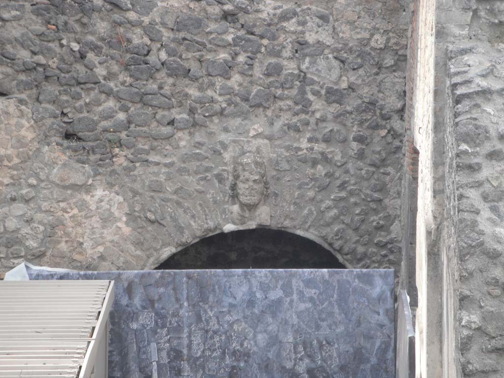 VIII.7.20 Pompeii. May 2011.
West side, during renovation work. Head of Bacchus over entrance to room under the seating. Photo courtesy of Ivo van der Graaff.