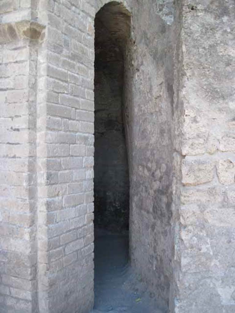 VIII.7.21 Pompeii. September 2010. Entrance way to the latrine. The latrine entrance is located to the left of the stairs leading to the summa cavea of the large theatre. This is between the triangular forum and the principal access door to the theatre crypta. Photo courtesy of Drew Baker.