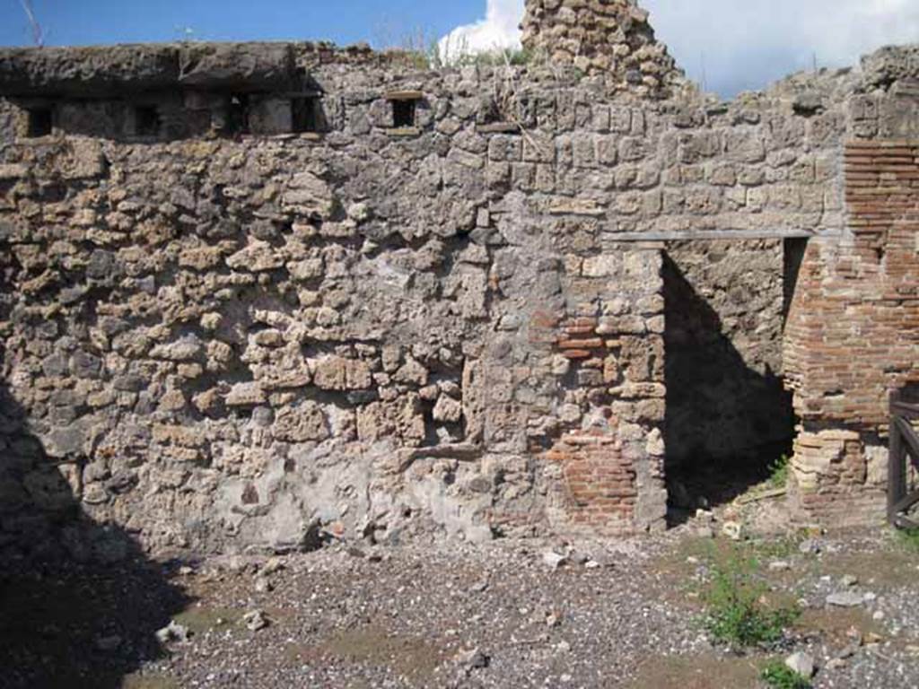 VIII.7.23 Pompeii. September 2010. North wall of shop, with doorway to latrine, on right. Photo courtesy of Drew Baker.