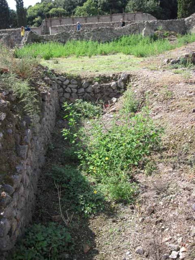 VIII.7.24 Pompeii. September 2010. South-west corner of south portico of garden area. Also looking west towards upper level of theatre across garden of VIII.7.26. Photo courtesy of Drew Baker.
