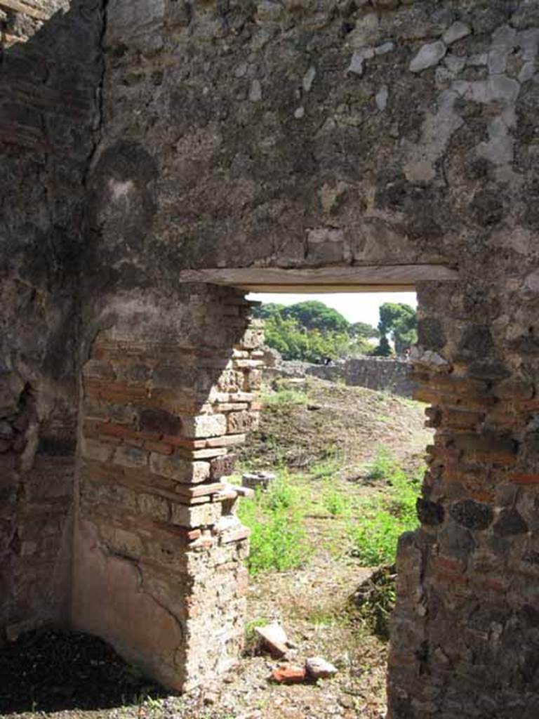 VIII.7.26 Pompeii. September 2010. South wall and south-east corner, looking south through doorway onto north portico. Photo courtesy of Drew Baker.