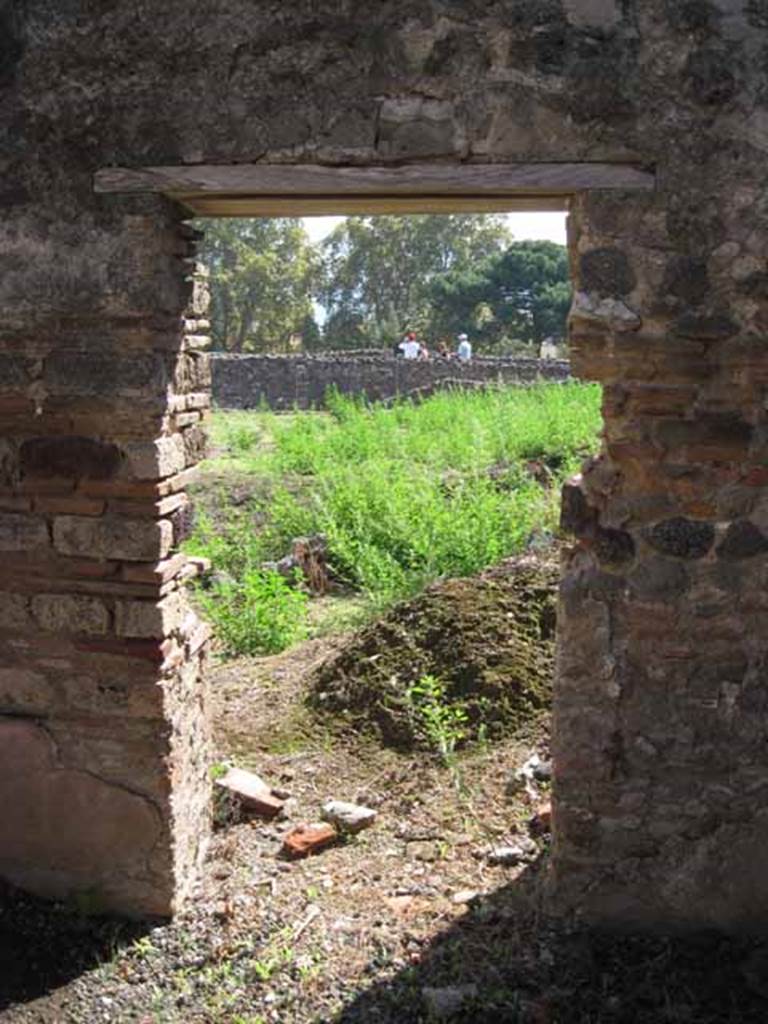 VIII.7.26 Pompeii. September 2010. Doorway in south wall of fourth room, looking south across garden area. Photo courtesy of Drew Baker.