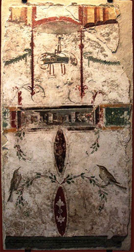 VIII.7.28 Pompeii. Part of the portico? Painting with basket, two birds and a landscape.
In the upper part a basket is suspended between two garlands, possible allusion to one of the rites of the cult to Bacchus, in which sacred objects were transported in baskets.
At the bottom are two birds delicately landed in branches.
The frame with a landscape placed in the centre was added later, perhaps to fill the space then empty.
Now in the Museu Nacional/UFRJ Brazil.
Following the disastrous fire at the Museum on 3rd September 2018 this may have been destroyed.
Este afresco aproxima-se estilisticamente das pinturas de Herculanum e de Stabies. Apresenta na parte superior um cesto suspenso entre duas guirlandas, possível alusão a um dos ritos do culto a Baco, em que objetos sagrados eram transportados em cestos. Na parte inferior estão dois pássaros delicadamente pousados em ramagens. O quadro com uma paisagem colocado no centro foi acrescentado posteriormente, talvez para preencher o espaço então vazio.
See http://www.museunacional.ufrj.br/dir/exposicoes/arqueologia/culturas-mediterraneo/arqcmed004.html