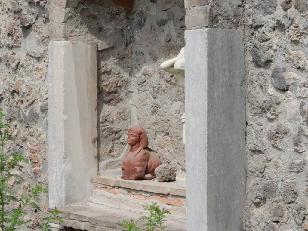VIII.7.28 Pompeii. May 2017. Niche with reproduction pottery sphinx in north-west corner of the sacred room or Hall of initiation.
Now in Naples Archaeological Museum. Inventory number 22572.
Also in the niche is a reproduction marble statue of Venus Anadyomene (Venus drying her hair after a bath).
Found against the west wall of the portico in the south west corner.
Now in Naples Archaeological Museum. Inventory number 6298.
Photo courtesy of Buzz Ferebee.