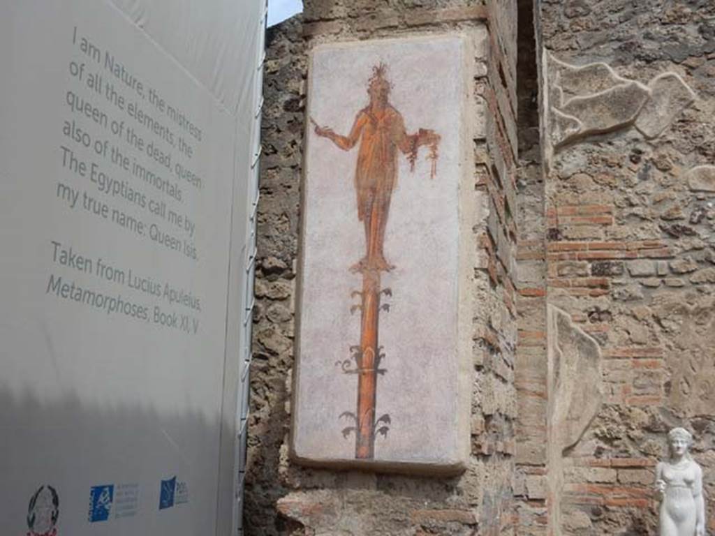 VIII.7.28 Pompeii. May 2017. North wall of second arch from north in the Ekklesiasterion.
Reproduction of fresco of statue carrying sistrum and box, at the top of a candelabra.
Photo courtesy of Buzz Ferebee.