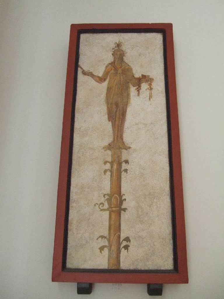 VIII.7.28 Pompeii. Priestess on a candelabrum carrying offerings on a tray.
Found in passageway of arch. Now in Naples Archaeological Museum.