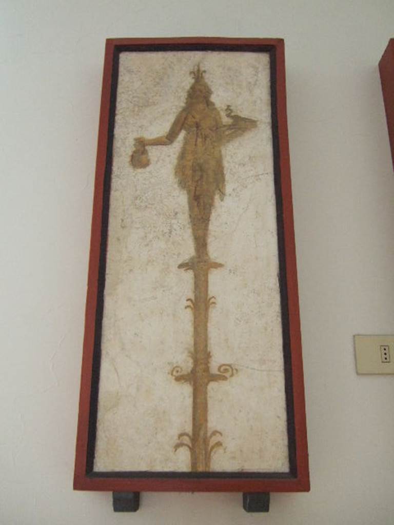 VIII.7.28 Pompeii. Priestess on a candelabrum with jar and peacock. Found in passageway of arch. Now in Naples Archaeological Museum.