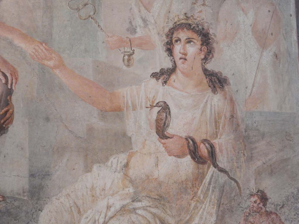 VIII.7.28 Pompeii. June 2019. Detail of Isis offering her right hand to Io and holding a cobra in her left.
Found in the centre of the south wall of the Ekklesiasterion in November 1765.
Now in Naples Archaeological Museum. Inventory number 9558. Photo courtesy of Buzz Ferebee.
