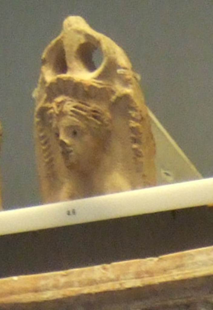 VIII.7.28 Pompeii. Egyptian styled antefix with female bust, with naked breasts, and wearing a diadem.
Similar figures modelled in stucco were found on the walls of the purgatorium.