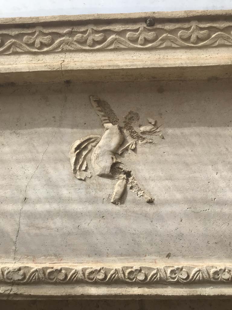 VIII.7.28, Pompeii. April 2019. Purgatorium, architrave in centre of south side, detail of flying cupid.
Photo courtesy of Rick Bauer.