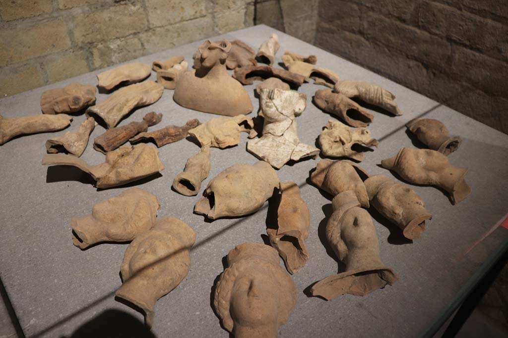 VIII.7.31 Pompeii. February 2021. Display of terracotta ex-votos of female heads, on display in Antiquarium.
Photo courtesy of Fabien Bièvre-Perrin (CC BY-NC-SA).