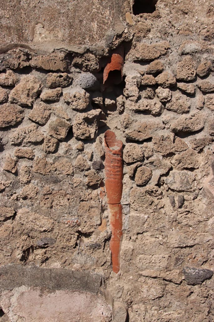 IX.1.1 Pompeii. October 2022.
Downpipe in north wall, from upper floor. Photo courtesy of Klaus Heese.