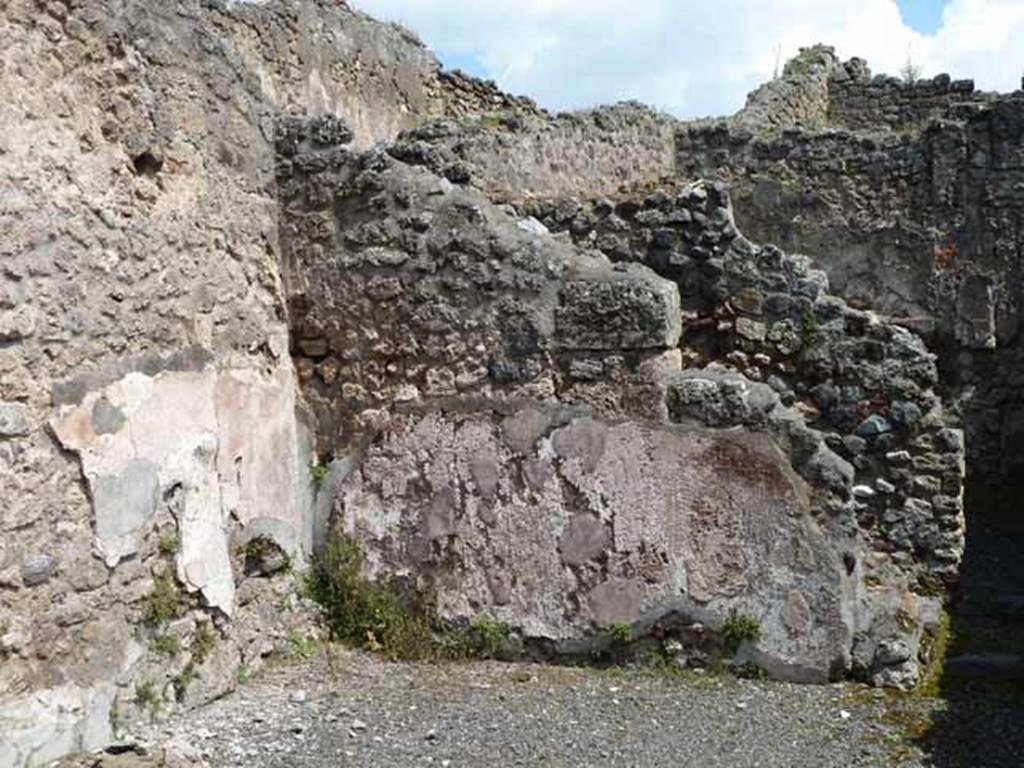 IX.1.1 Pompeii. May 2010. East wall of shop, with site of latrine behind it.