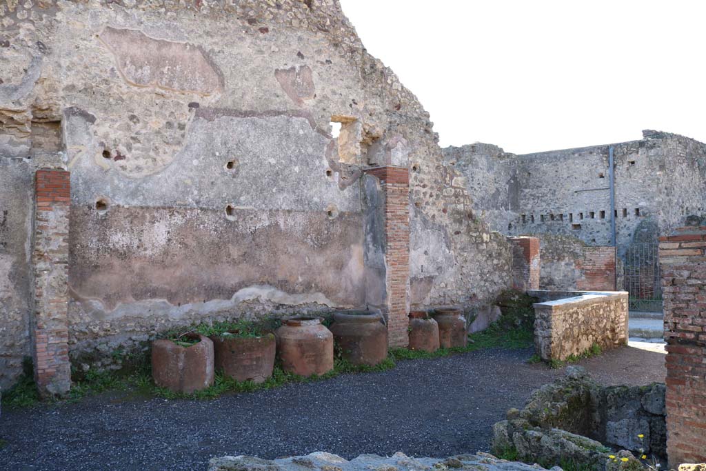 IX.1.3 Pompeii. December 2018. Looking south-west towards rear of counter, and south wall. Photo courtesy of Aude Durand.