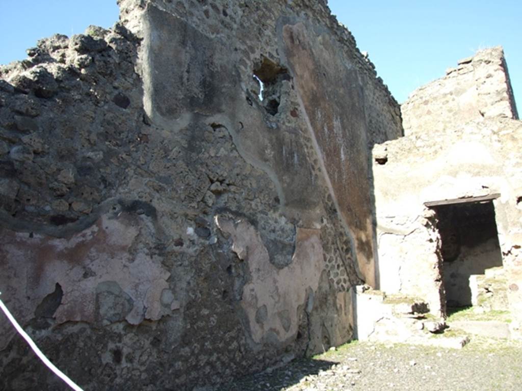 IX.1.4 Pompeii. March 2009. Stone steps in north-east corner of shop with outline of stairs in remains of high zoccolo/plinth of cocciopesto on north wall.