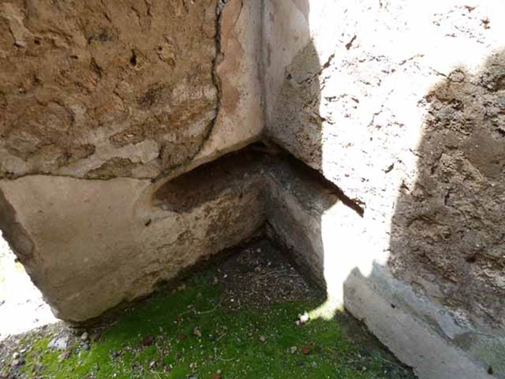 IX.1.4 Pompeii. May 2010. Latrine in north-west corner of rear room.
This is described as having two slots at right angles to each other, in the kitchen area with no privacy. This might suggest a triangular seat.
See Hobson, B., 2009. Latrinae et foricae: Toilets in the Roman World. London; Duckworth. (p.49 and fig. 64)
