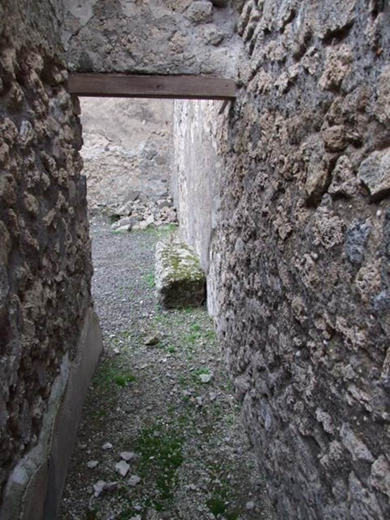 IX.1.7 Pompeii. December 2007. Looking north. Small corridor along east wall leading to room in north-east corner, previously stairs to upper floor kitchen with cupboard under.