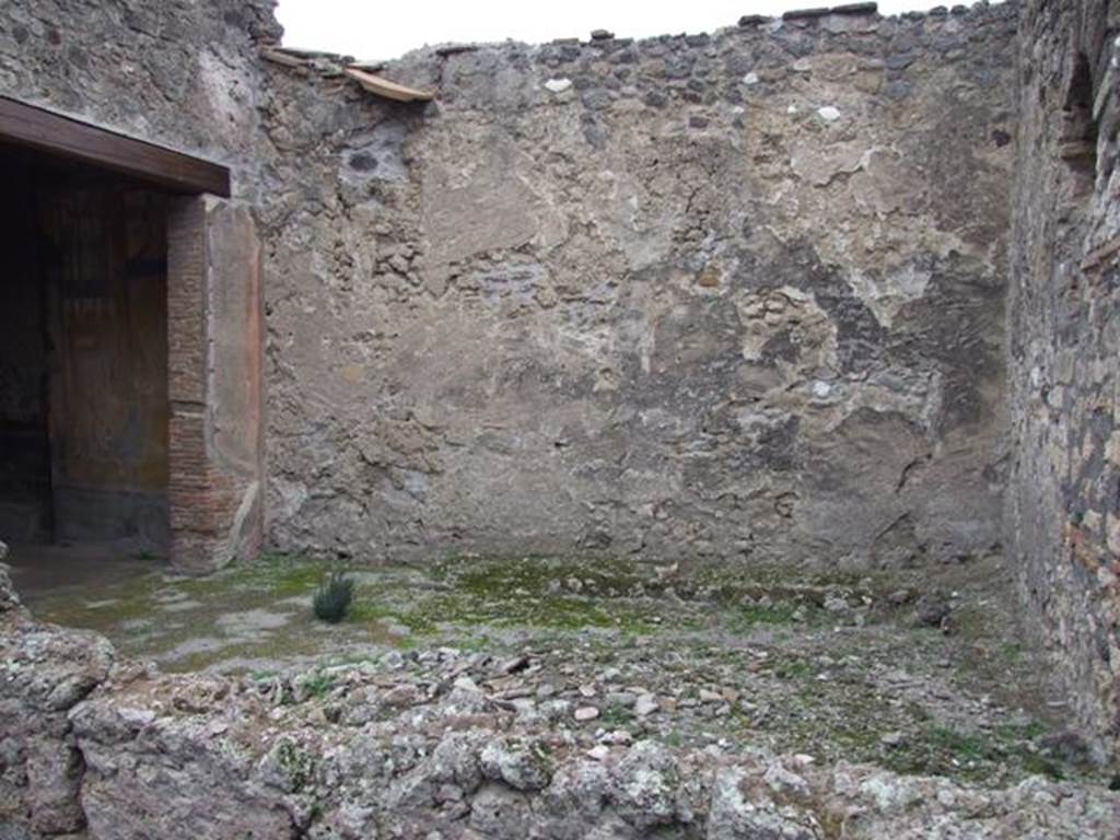 IX.1.7 Pompeii. December 2007. Garden area, looking north. According to Jashemski,
“the small garden to the left of the atrium had a raised planting bed attached to the wall at the edge of the garden, on the east and on much of the north wall. The low wall with space for plants continued on the south side, separating the garden from the atrium. The house was small but well decorated. Two marble tondi (Naples inventory 109 288, and 6622) were found in the garden; the marble Herm of Bacchus (Naples inv. 109 518) and the marble Statuette of Attis attached to a little support (Naples inv. 120 402), as well as 2 marble pine-cones (fountains ?) may have been garden decorations. The triclinium on the west opened onto the garden. There was also an entrance doorway to the garden from the atrium”.
See Jashemski, W. F., 1993. The Gardens of Pompeii, Volume II: Appendices. New York: Caratzas. (p.225)
According to Lucia Anna D’Acunto, the following marble objects were found in this garden, atrium and second room to the left. Marble disc (Oscillum), found in garden on 21.4.1857, Naples Inventory number 6622. White marble decorative shield (Clipeo) found in garden on 2.8.1871, Naples inventory number 109288. Herm of Dionysius, found in second room to the left on 28.5.1866, Naples inventory number 109518. Table support (Trapezoforo) of a young boy with phrygian cap, found in atrium on 3.5.1866, Naples inventory number 120402.
See Pompeian marble in the Naples Museum (SAP book 26), by Carrella, A; D’Acunto, L.A; Inserra, N; and Serpe, C. (p.160-2)