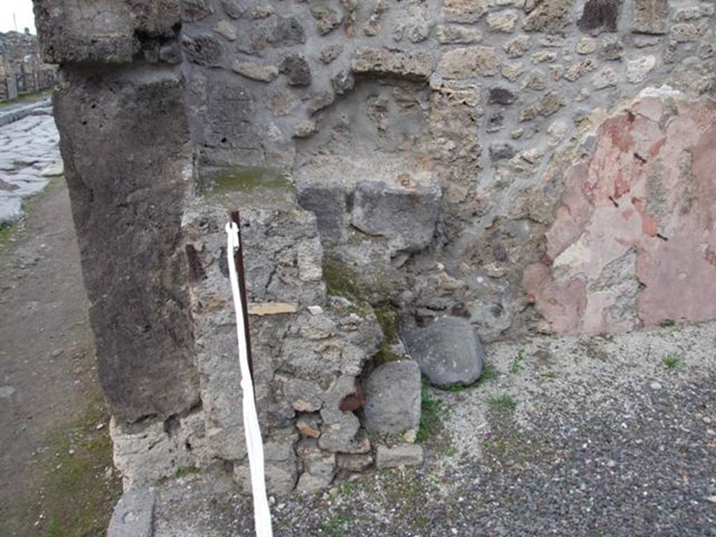 IX.1.8 Pompeii. December 2007. North-west corner of bar room, near entrance doorway, remains of hearth.
