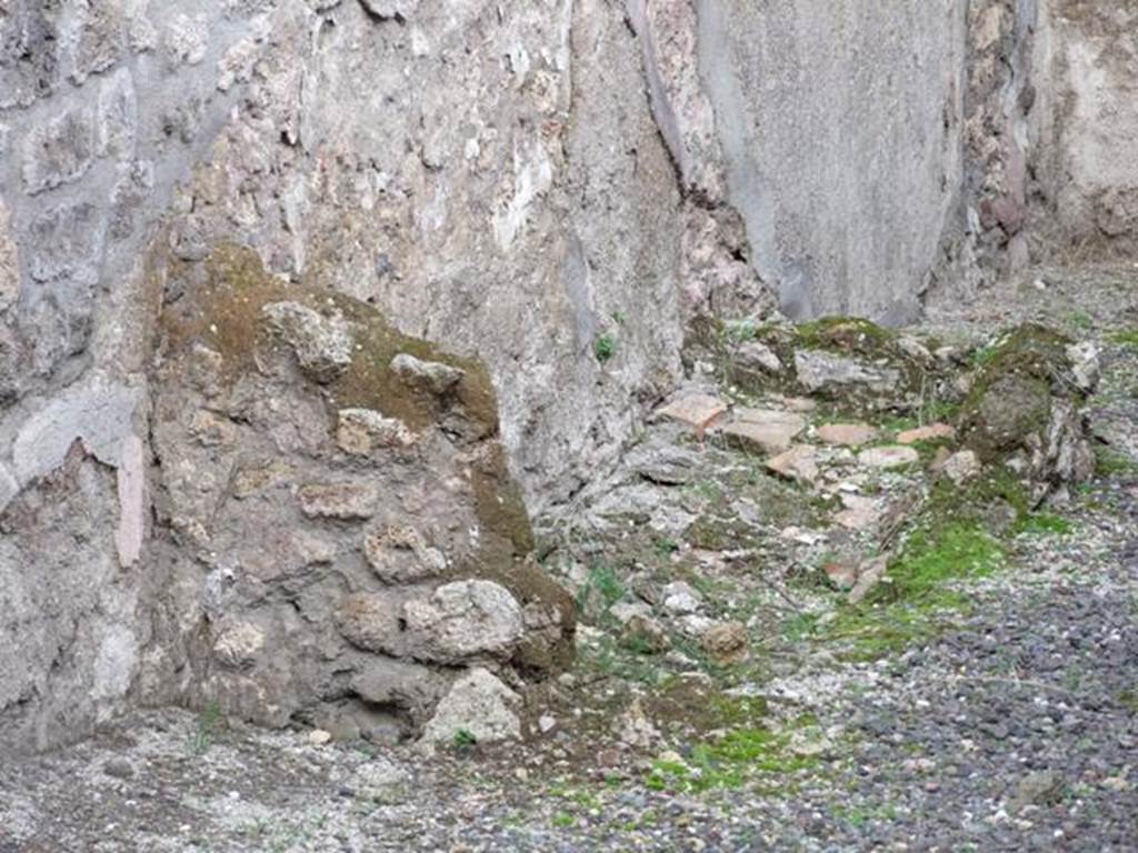 IX.1.8 Pompeii. December 2007. Remains of base of steps to upper floor against the north wall in rear room.