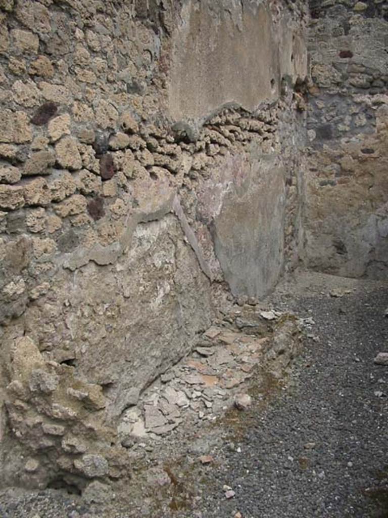 IX.1.8 Pompeii. May 2003. Remains of base of steps to upper floor, with latrine beneath, against the north wall in rear room. Photo courtesy of Nicolas Monteix.