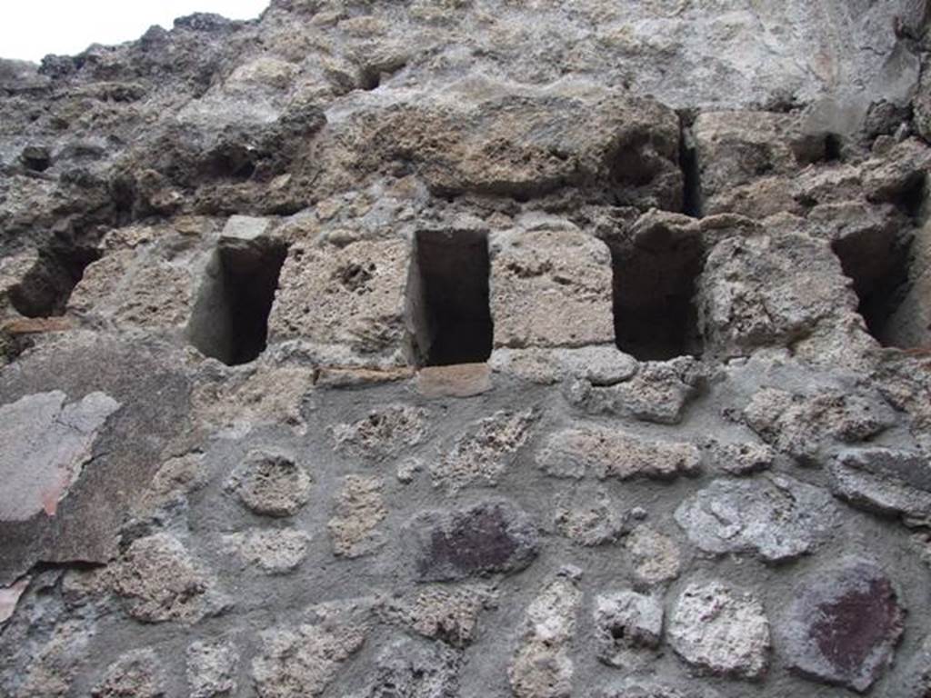 IX.1.12 Pompeii. December 2007.
South wall of room with open doorway in centre of south wall of atrium showing holes for upper floor supports.