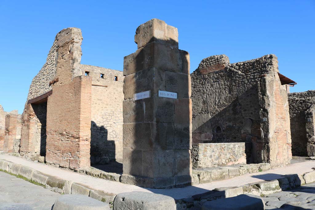 IX.1.15, Pompeii, centre left, and IX.1.16, centre right, Pompeii. December 2018.
Looking north-east from Holconius’ crossroads, towards bar with two entrances. Photo courtesy of Aude Durand.