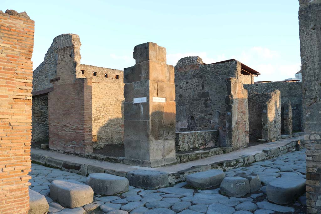 IX.1.15 Pompeii, centre left, and IX.1.16, centre right on Via dell’Abbondanza. December 2018.
Looking north-east from Holconius’ crossroads, towards bar with two entrances. Photo courtesy of Aude Durand.