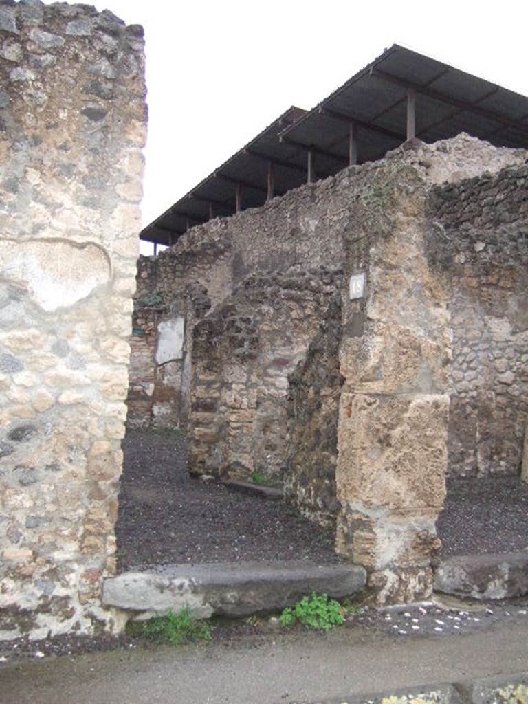 IX.1.18 Pompeii. December 2005. Entrance on Via dell�Abbondanza.
According to Della Corte, graffiti found on the left of the entrance of IX.1.18, was

Lollia  cum  suis  (rogat)    [CIL IV 1053]

Della Corte also said that although he could not know what was worked or sold here, he knew that Lollia Successa was the proprietor of the business.
See Della Corte, M., 1965.  Case ed Abitanti di Pompei. Napoli: Fausto Fiorentino. (p. 242)
For the other graffiti found on the pilaster between IX.1.17 and IX.1.18, on the left, see IX.1.17.

Graffiti found in March 1858, on the pilaster between IX.1.18 and IX.1.19, on the right, were

M(arcum)  E(pidium)  [S(abinum)]
II vir(um)     [CIL IV 1056]

A(ulum)  Suettium
aed(ilem)  d(ignum)  r(ei)  [p(ublicae)]
o(ro)  v(os)  f(aciatis)    [CIL IV 1057]

Sabinum
[    [CIL IV 1058]

See Pagano, M. and Prisciandaro, R., 2006. Studio sulle provenienze degli oggetti rinvenuti negli scavi borbonici del regno di Napoli.  Naples : Nicola Longobardi.  (p. 175)

