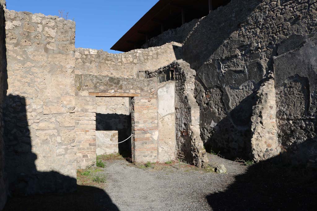 IX.1.18 Pompeii. December 2018.
Looking towards doorway to cubiculum, centre left, and doorway to a rustic storeroom or cupboard in north-east corner of yard, on right.
Photo courtesy of Aude Durand.