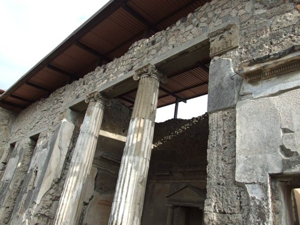 IX.1.20 Pompeii. December 2007. Room 2. Atrium on east side. Room 6 Ala, with household shrine, 2 Ionic columns in opening, and figured capitals on either side.