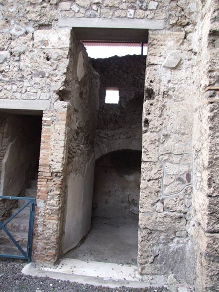 IX.1.20 Pompeii. December 2007. Doorway to Room 15, with staircase to upper floor visible above the arch at rear.