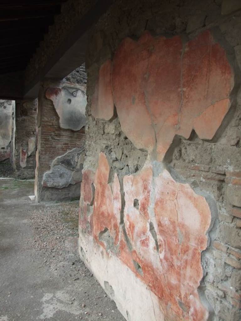 IX.1.22 House of M. Epidi Sabini. December 2007. Room 14. First peristyle. Painted plaster on north wall and doorways of rooms 20 and 21.