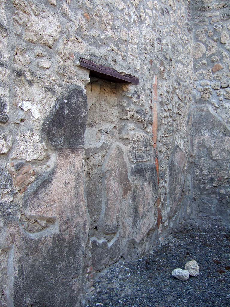 IX.1.23 Pompeii. September 2005. West wall of shop with recess, or blocked door from antiquity, and downpipe.
According to Fiorelli, this shop had belonged to the same house at IX.1.22, so the blocked doorway would have originally led into the entrance corridor of that house.
See Fiorelli, G. (1875). Descrizione di Pompei, (p.376)
See Pappalardo, U., 2001. La Descrizione di Pompei per Giuseppe Fiorelli (1875). Napoli: Massa Editore. (p.140)
According to Hobson, there was a downpipe in the west wall, and that Eschebach had indicated a latrine.
See Hobson, B., 2009. Pompeii, Latrines and Down Pipes. BAR International series 2041. Oxford. Hadrian Books. (p.475).
According to Eschebach, there was a latrine under the steps to the upper floor.
See Eschebach, L., 1993. Gebäudeverzeichnis und Stadtplan der antiken Stadt Pompeji. Köln: Böhlau. (p.403).
