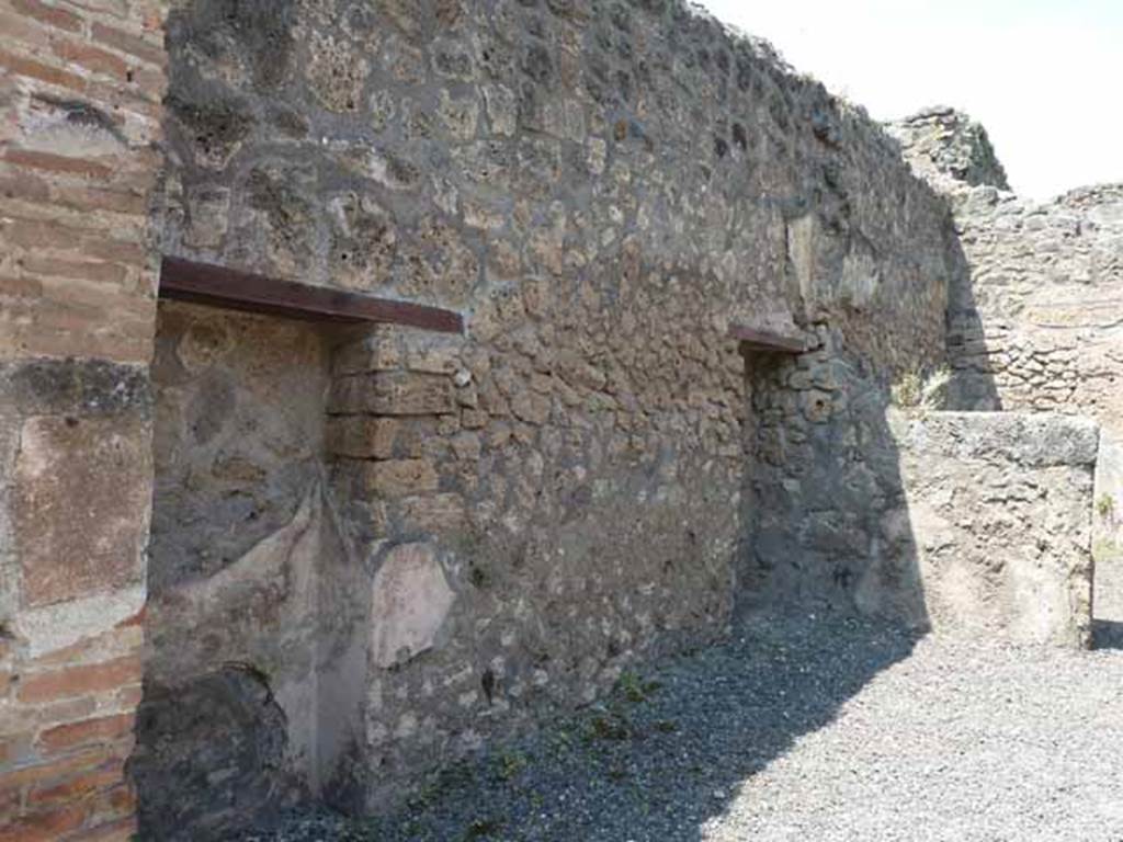 IX.1.24 Pompeii. May 2010. West wall with two blocked doorways or rectangular niches.
According to Fiorelli, this shop would have originally have belonged to the house at IX.1.22, having two blocked doorways on its left side which would have put it into communication with the shop at IX.1.23 and therefore the house at IX.1.22. At the rear of the shop was a small room, with the stairs to the upper area.
See Fiorelli, G. (1875). Descrizione di Pompei, (p.376)
See Pappalardo, U., 2001. La Descrizione di Pompei per Giuseppe Fiorelli (1875). Napoli: Massa Editore. (p.140)