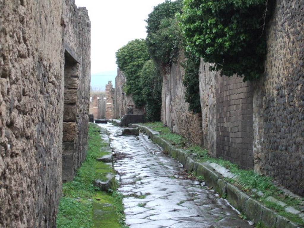 IX.1.28 Pompeii. December 2005. Vicolo di Tesmo looking north. IX.7, on right.
According to Fiorelli,
On the corner pilaster, amongst other graffiti, was written - AMPLIATVM AED
V . B . VICINI . ROG
Turning the corner, a stable was found that had a lowered edge in front of the doorway, for easier access by the animals, and had an area, of which only a small part was uncovered, having at the rear two rooms with a latrine, and a large stall to the right. It was used perhaps and annexed to the house at IX.1.22
Found on an adjacent wall, on a whitewashed piece, was -
L . ALBVCIVM . AED
THESMVS . LIBERT . ROG
See Fiorelli, G. (1875). Descrizione di Pompei, (p.376-7)
See Pappalardo, U., 2001. La Descrizione di Pompei per Giuseppe Fiorelli (1875). Napoli: Massa Editore. (p.140)