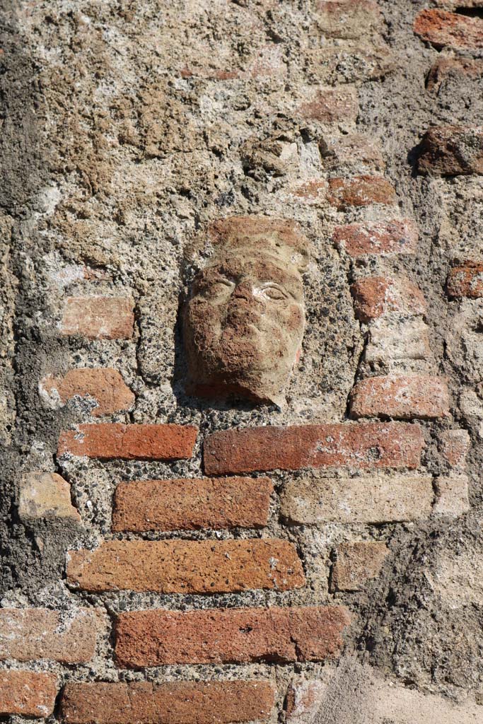 Pilaster between IX.2.2 and IX.2.3, Pompeii. December 2018
Terracotta face. Photo courtesy of Aude Durand.