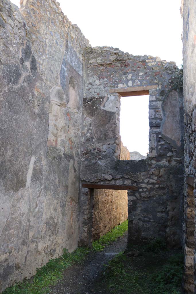 IX.2.8 Pompeii. December 2018.
Looking west from rear room, looking towards south-west corner with niche latrine in upper wall and downpipe below.
Photo courtesy of Aude Durand.