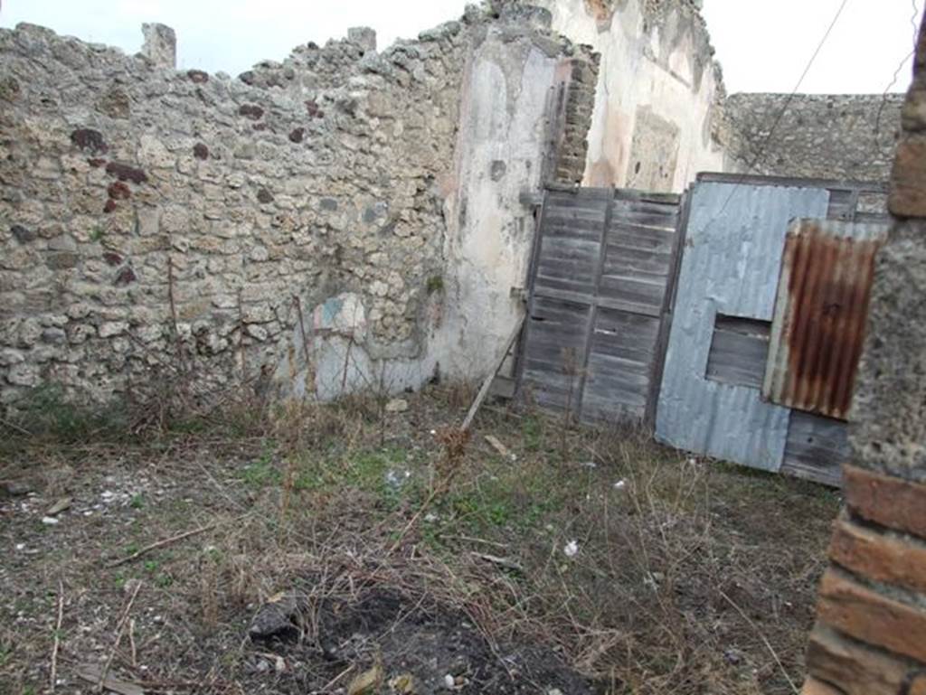 IX.2.16 Pompeii. December 2007. Tablinum, looking east. According to Bragantini, the floor would have been of lavapesto with marble insets. The wall dado would have been white, panelled with compartments of painted plants. The middle zone of the walls would have been red. The red north wall showed divisions painted in azure blue. The east wall was red. The south wall was panelled in red. The central panel contained the painting of the Three Graces. The side panels had vignettes, but they had faded. The panels were separated by painted candelabra at the base of the blue divisions. The upper zone had faded, but architectural designs would have been seen there. The west wall had red panels with borders of azure blue, with a faded vignette. The upper zone was red.
See Bragantini, de Vos, Badoni, 1986. Pitture e Pavimenti di Pompei, Parte 3. Rome: ICCD. (p.416, tablino ‘k’)
According to Sogliano, other paintings found in the tablinum were –
Head of a young Satyr, on a white background (p.42, no.183)
Young Satyr and Old Satyr (2 paintings), both on white background (p.43, nos.188/189)
A Bacchante with bacchic attributes, on a white background (p.47, no.211)
A flying Cupid (p.57, no.298)
Flying Psyches (5 paintings) (p.66, nos.383/4/5/6/7)
See Sogliano, A., 1879. Le pitture murali campane scoverte negli anni 1867-79. Napoli: Giannini.
See BdI, 1871, p.200-204