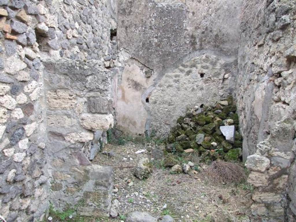 IX.2.16 Pompeii. December 2007. Small storeroom on south-east side of peristyle next to staircase, shown as room “o” in PPM.
On the right of the photo is the doorway leading into a corridor, at the far end of the corridor is the kitchen.
According to Schefold, the location of the lararium was in this room.
See Schefold, K., 1957. Die Wände Pompejis. Berlin: De Gruyter. (p.241-243)
According to BdI, “from the corridor, a side door gave access to a square room, which has not conserved any of the original decoration other than traces of figures enclosed in red and black compartments and a lararium painting divided into two zones”.
See Bullettino dell’Instituto di Corrispondenza Archeologica (DAIR), 1871, (p. 201)
According to Giacobello –
The painting was seen on the north wall of a storeroom/cupboard (room “o”).
See Giacobello, F., 2008. Larari Pompeiani: Iconografia e culto dei Lari in ambito domestico. Milano: LED Edizioni, (p.204, no.97)