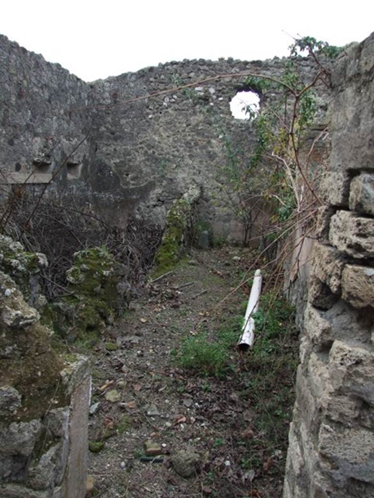 IX.2.16 Pompeii. December 2007. Looking along south side of remains of peristyle garden area, through doorway into corridor leading to kitchen area.
