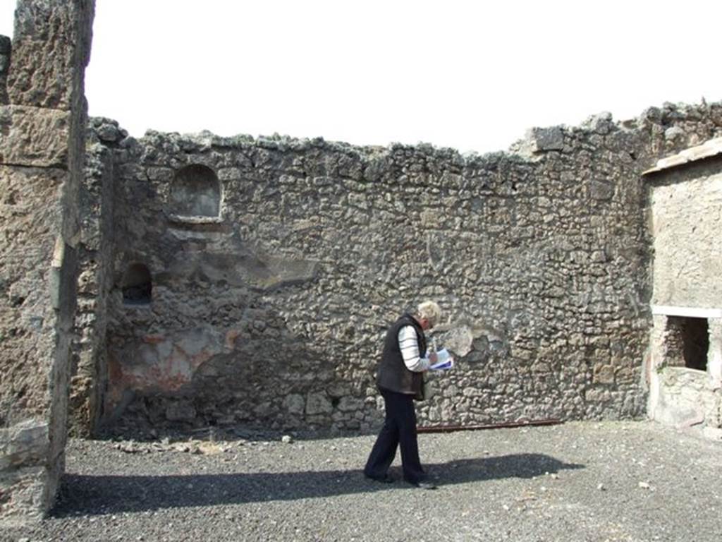 IX.2.17 Pompeii. March 2009. Room 1, atrium, two niches in west end of north wall. According to Boyce, the walls of both were coated with white stucco. Fiorelli referred to them as due nicchie per I Penati.
See Boyce G. K., 1937. Corpus of the Lararia of Pompeii. Rome: MAAR 14. (p.81)
The remains of the high red zoccolo can be seen on the north wall below the niches.
