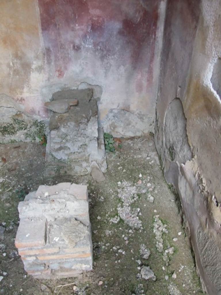 IX.2.21 Pompeii. March 2009. Room 2, south-west corner. According to Boyce, found in this room that Fiorelli described as un cubiculo divenuto Larario, was a square brick base with a depression in its upper surface for a statue base and in front of it was a square brick altar.
See Boyce G. K., 1937. Corpus of the Lararia of Pompeii. Rome: MAAR 14. (p.81, no. 400)