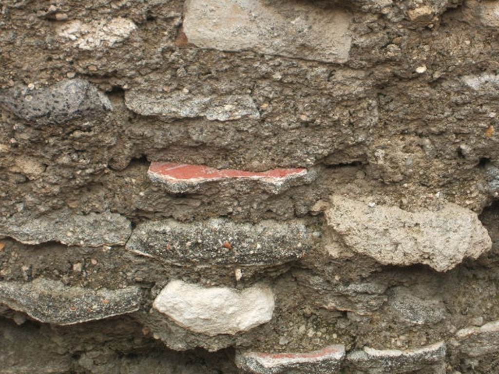 IX.2.23 Pompeii. May 2005. Original plaster used to build/repair wall